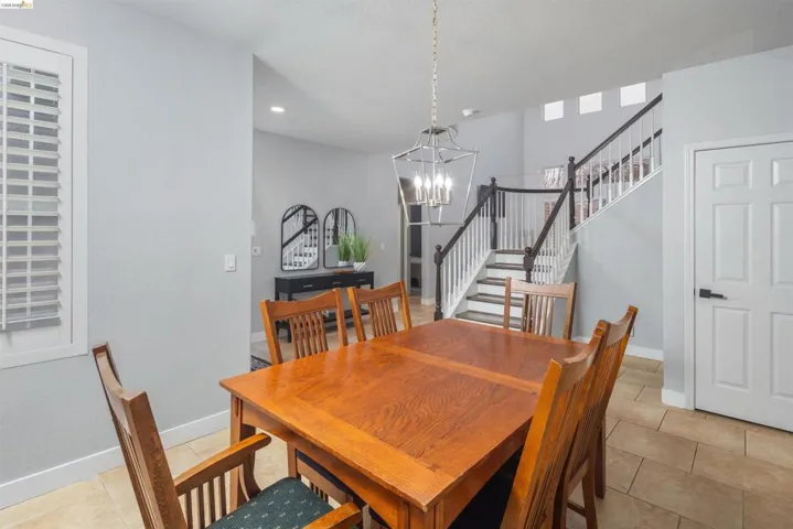 Dining space featuring stairway, a chandelier, and light tile patterned floors