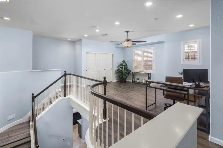 Office area featuring dark wood-type flooring, recessed lighting, and ceiling fan