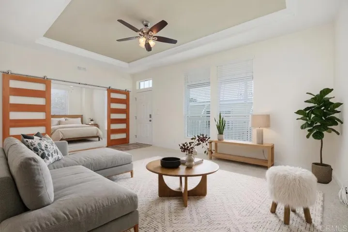 Living room virually staged Note ceiling fan and tray ceiling