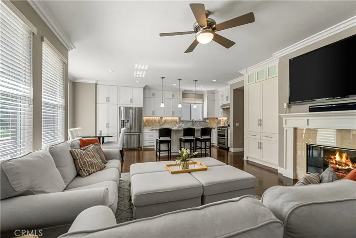 Another shot of the family room/kitchen. Note the ceiling fan,crown molding custom cabinetry and mantle. Fire has been digitally added to the fireplace