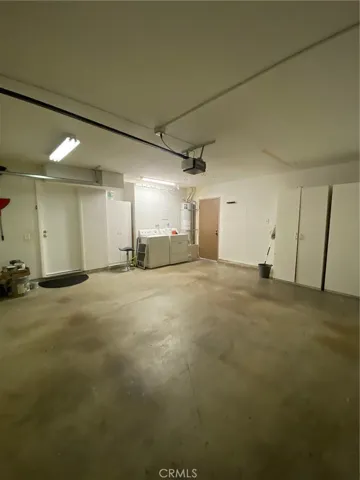 Garage with laundry, storage and opener.  back door opens to patio.