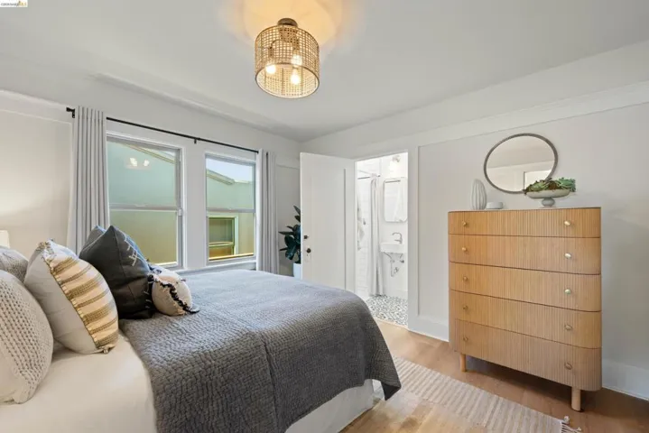 Bedroom featuring light wood-style flooring and connected bathroom