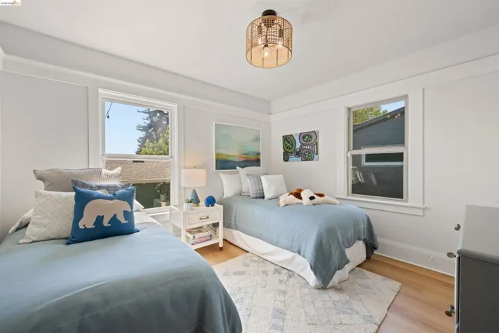 Bedroom with wood finished floors and baseboards