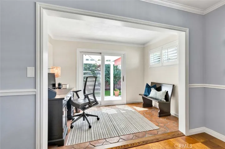 Office alcove with sliders to the patio is light & bright and has paver tile flooring.