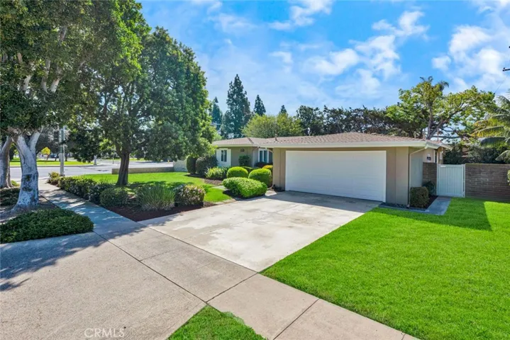 Large front lawn areas, two-car attached garage.