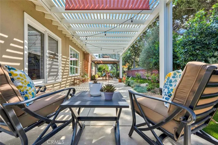 Long covered patio offers a variety of options for seating and dining options.