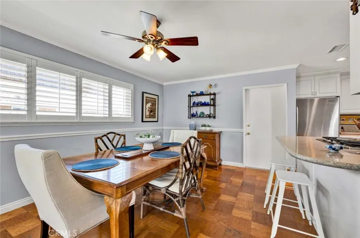 The dining room area adjoins the kitchen. There's informal bar seating at the counter as well.