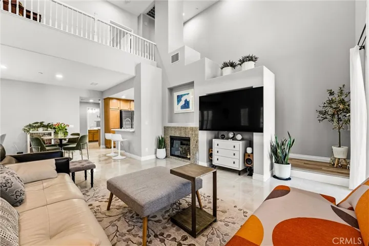 Bright and spacious great room featuring dramatic cathedral ceilings and open upper-level sightlines