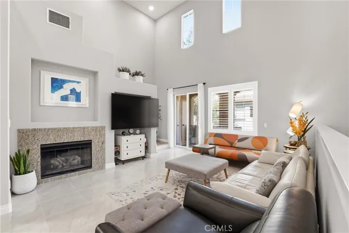 Cozy great room featuring a charming fireplace