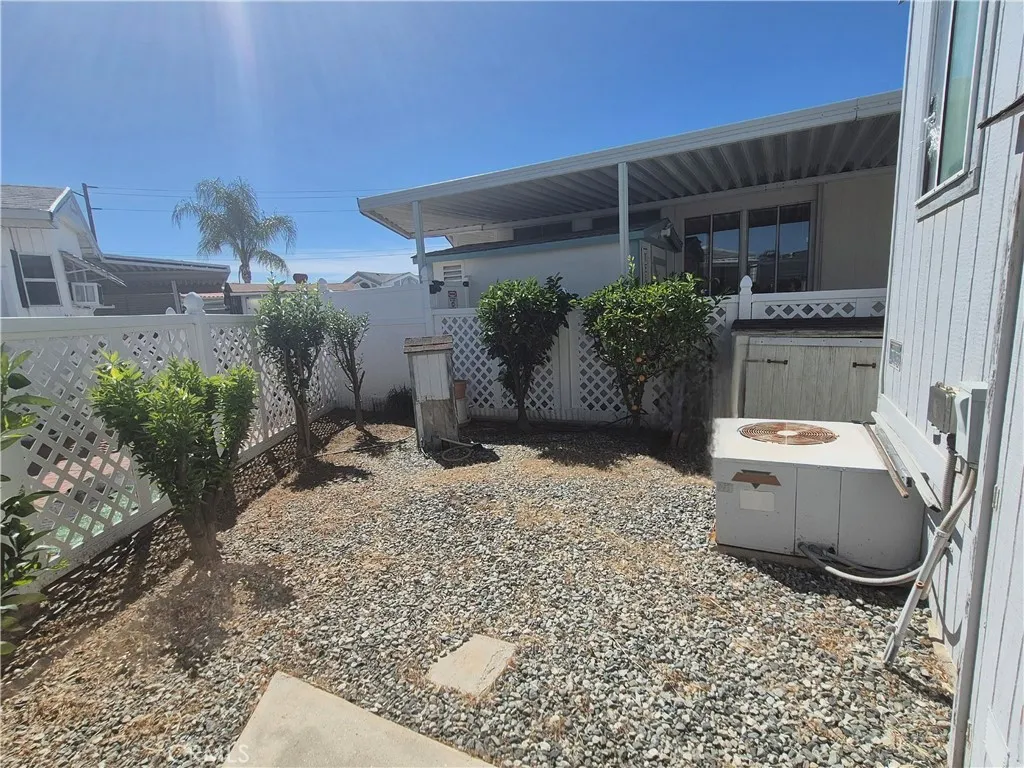 Backyard with Vinyl fencing and citrus grove