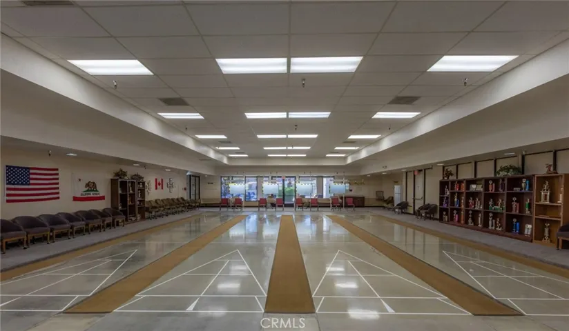 Shuffleboard Pavilion with bleachers and digital scoring system.
