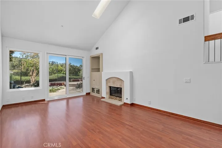 Fireplace in living room. Sliders opens into the oversize backyard