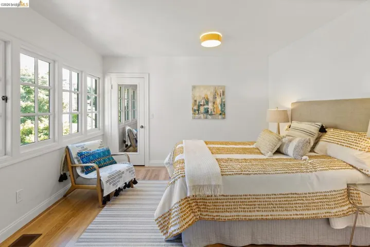 Bedroom with light wood finished floors and baseboards