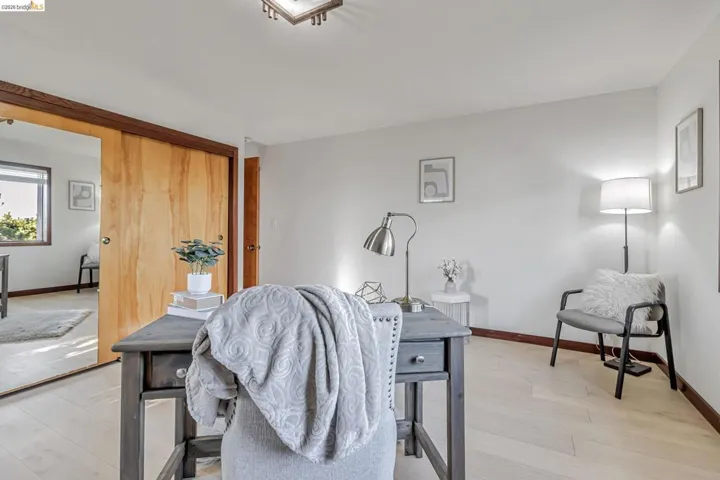 Living room with baseboards and light wood-style floors