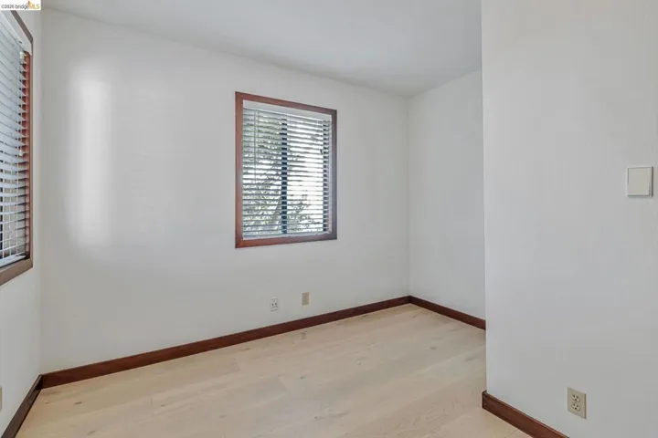 Empty room featuring light wood finished floors and baseboards