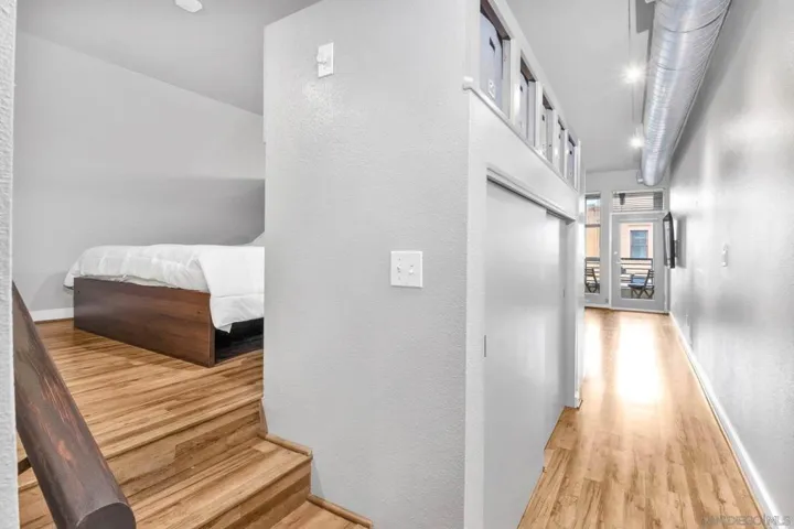 Lofted and chic bedroom has closet space and built in storage
