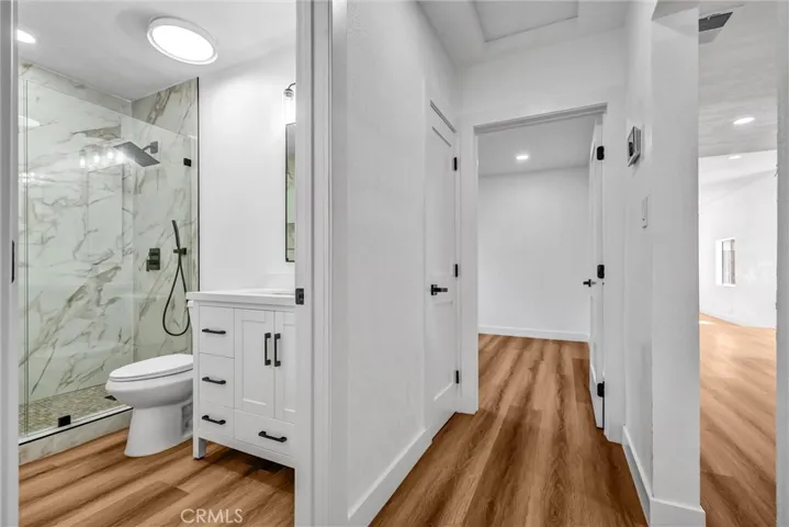 Hallway looking into 1 of the 2 bedrooms on the bottom floor