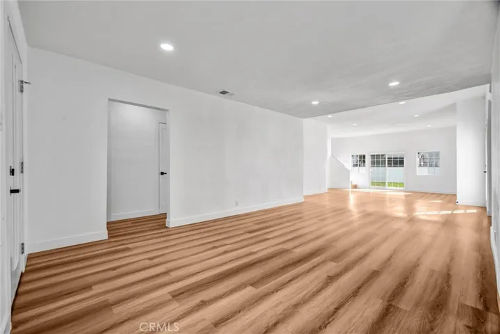 Living room facing hallway and backdoor