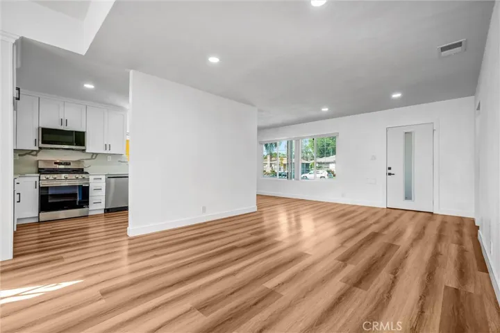living room, facing front door and kitchen