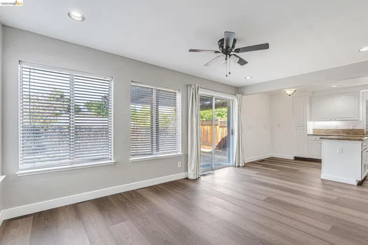 Unfurnished living room featuring a ceiling fan, recessed lighting, and light wood-style floors
