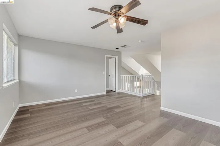 Spare room featuring a ceiling fan and light wood finished floors