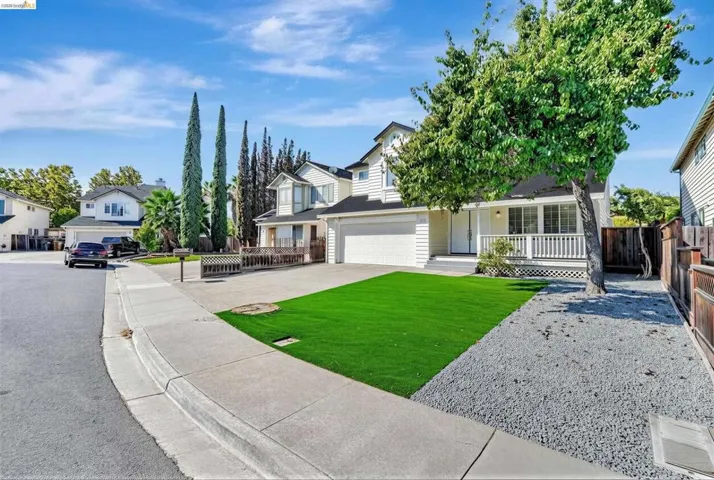 View of front of house featuring concrete driveway and a residential view