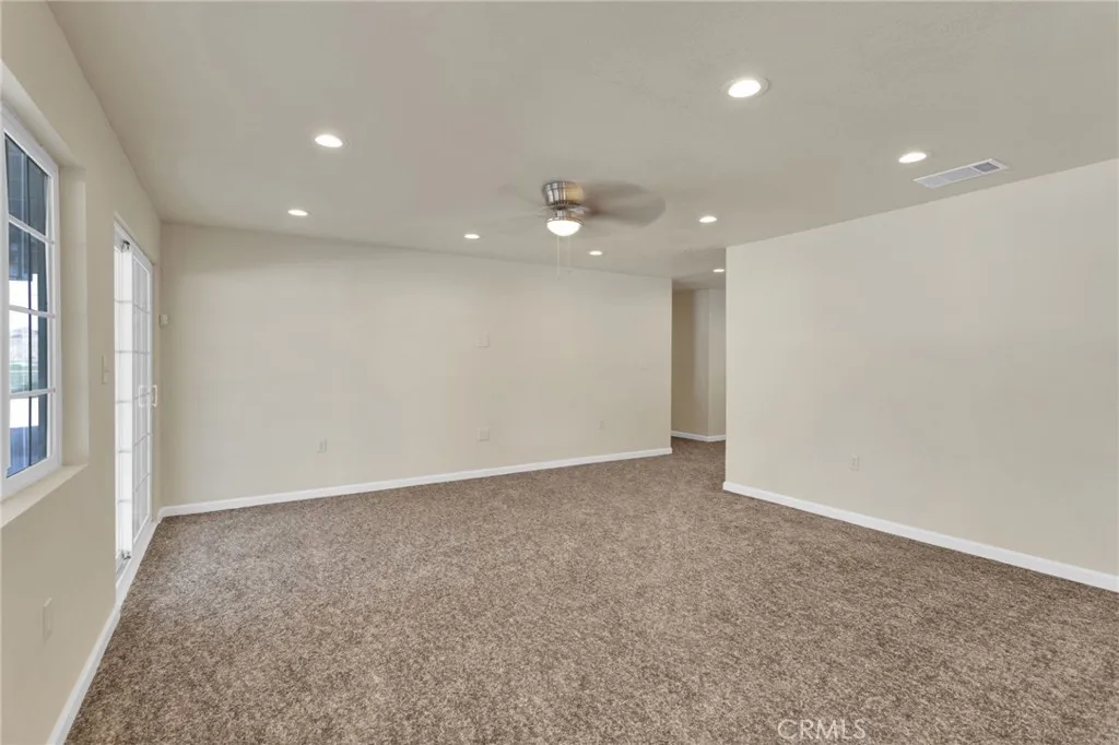 Spacious living area filled with natural light, designed with an open layout that flows seamlessly into the dining and kitchen spaces