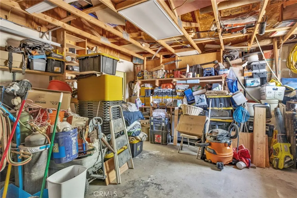 2 Car Garage on Detached shop featuring a bathroom and living space, offering potential for workshop use, storage, or future conversion.