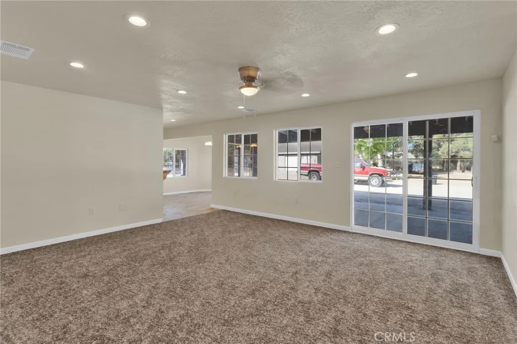 Spacious living area filled with natural light, designed with an open layout that flows seamlessly into the dining and kitchen spaces