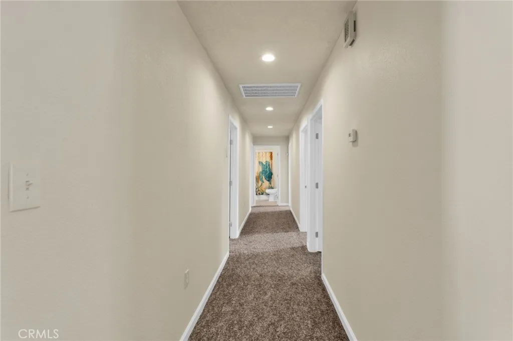 Extra-wide hallways enhance accessibility and contribute to the home’s open, airy feel.