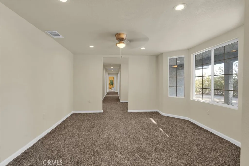 Formal living room offering a spacious and inviting setting, ideal for gatherings or a secondary lounge area