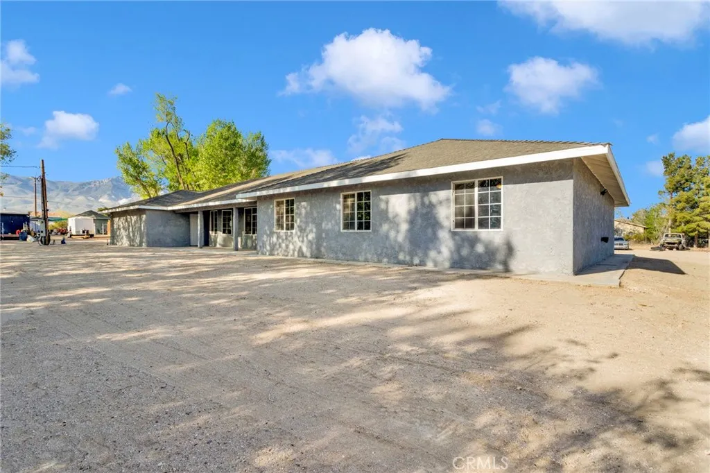 Newly constructed 2024 home situated on approximately 2.15 acres along a paved road, offering a clean modern design with expansive desert surroundings.