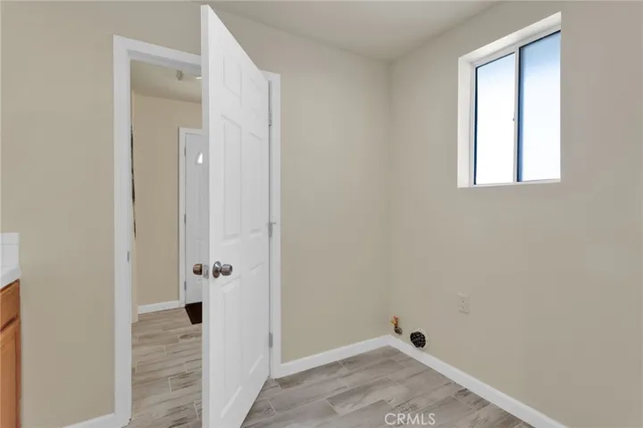 Dedicated laundry area with ample space for full-size appliances and additional storage, designed for everyday convenience