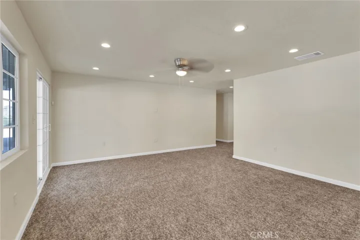Spacious living area filled with natural light, designed with an open layout that flows seamlessly into the dining and kitchen spaces