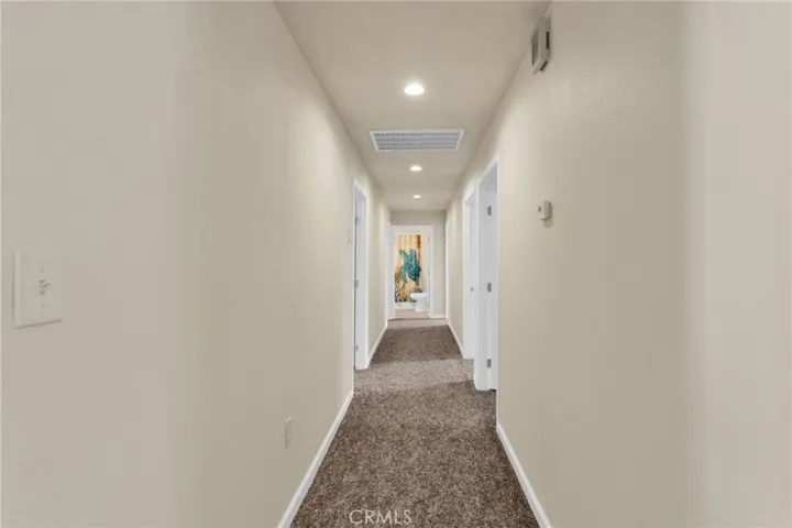Extra-wide hallways enhance accessibility and contribute to the home’s open, airy feel.