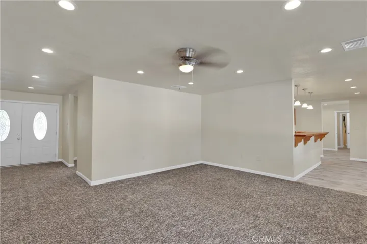 Spacious living area filled with natural light, designed with an open layout that flows seamlessly into the dining and kitchen spaces