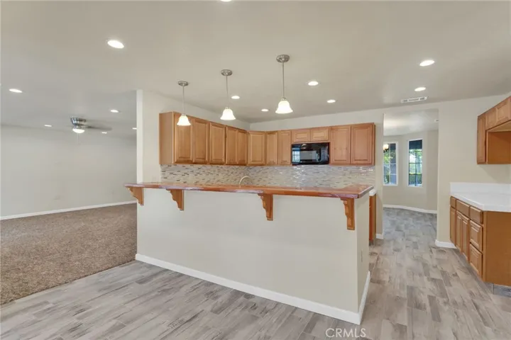 Functional kitchen layout featuring ample cabinetry, workspace, and direct connection to the main living areas.