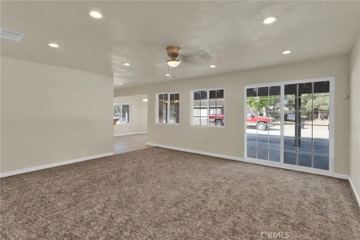 Spacious living area filled with natural light, designed with an open layout that flows seamlessly into the dining and kitchen spaces