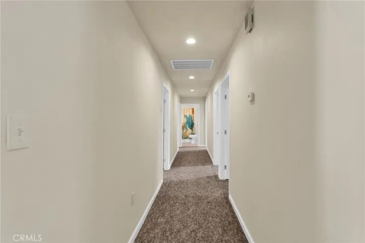 Extra-wide hallways enhance accessibility and contribute to the home’s open, airy feel.