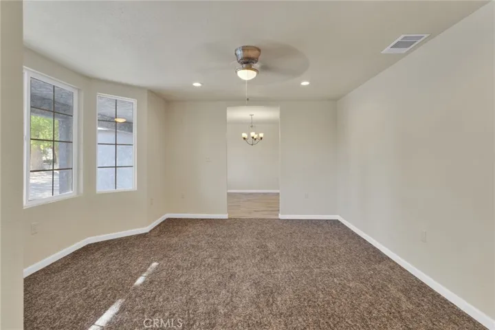 Formal living room offering a spacious and inviting setting, ideal for gatherings or a secondary lounge area