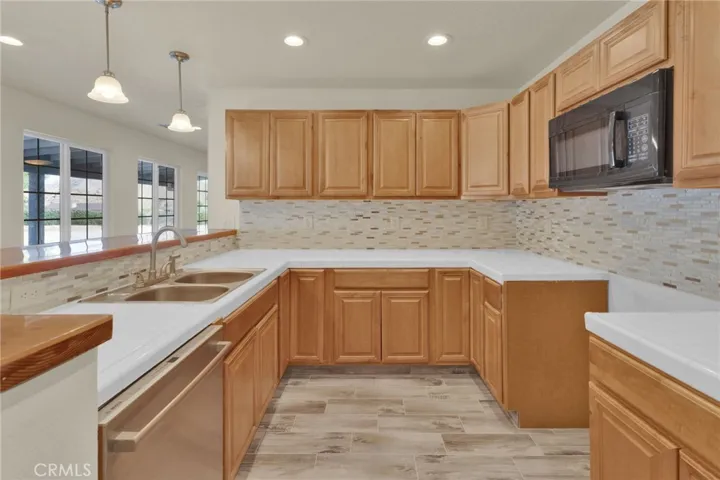 Functional kitchen layout featuring ample cabinetry, workspace, and direct connection to the main living areas.