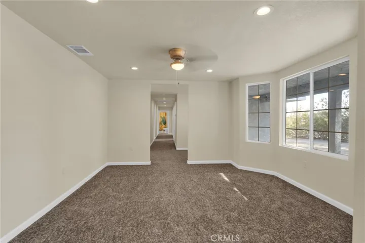 Formal living room offering a spacious and inviting setting, ideal for gatherings or a secondary lounge area