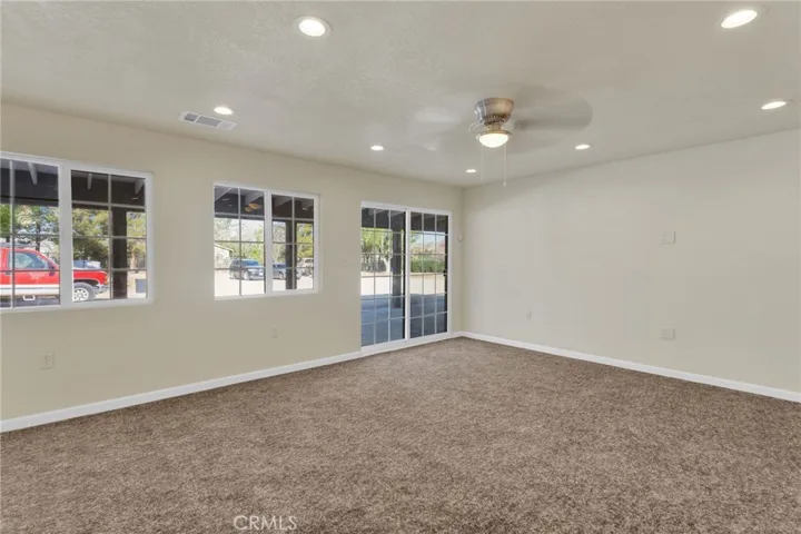 Spacious living area filled with natural light, designed with an open layout that flows seamlessly into the dining and kitchen spaces