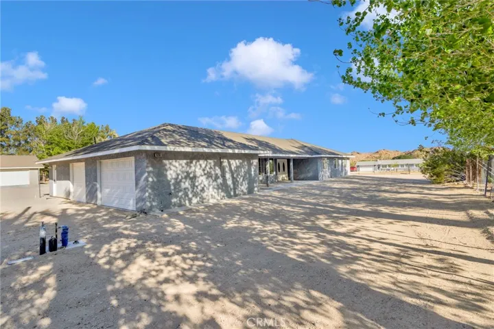 Newly constructed 2024 home situated on approximately 2.15 acres along a paved road, offering a clean modern design with expansive desert surroundings.