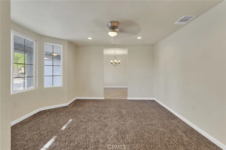 Formal living room offering a spacious and inviting setting, ideal for gatherings or a secondary lounge area