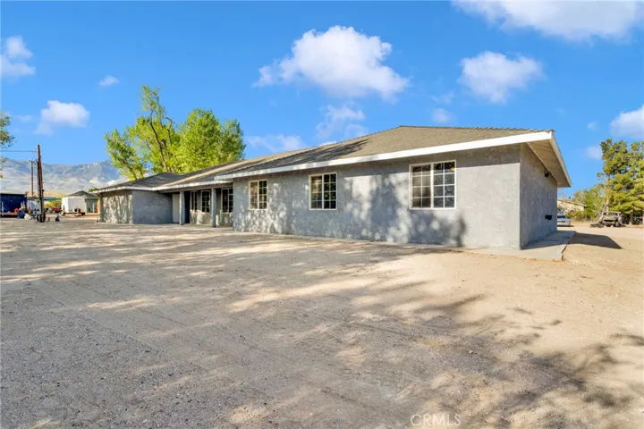 Newly constructed 2024 home situated on approximately 2.15 acres along a paved road, offering a clean modern design with expansive desert surroundings.