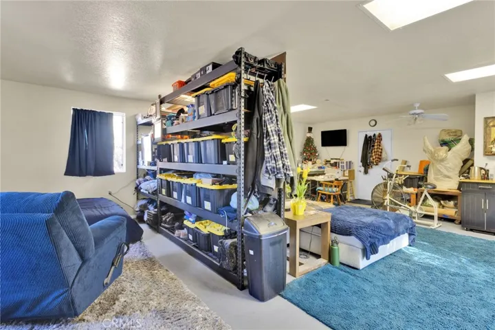 Detached shop featuring a bathroom and living space, offering potential for workshop use, storage, or future conversion.