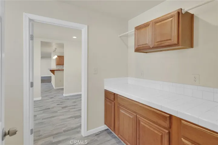Dedicated laundry area with ample space for full-size appliances and additional storage, designed for everyday convenience