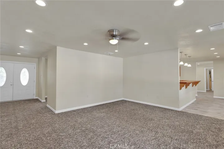 Spacious living area filled with natural light, designed with an open layout that flows seamlessly into the dining and kitchen spaces