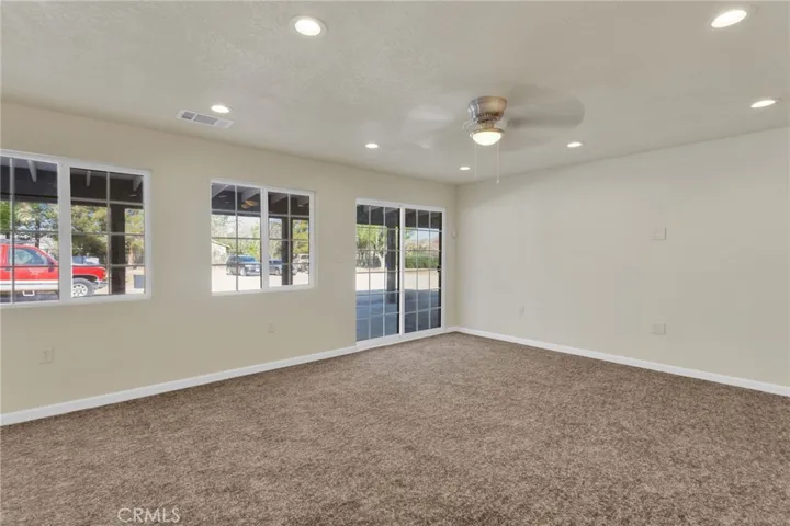 Spacious living area filled with natural light, designed with an open layout that flows seamlessly into the dining and kitchen spaces